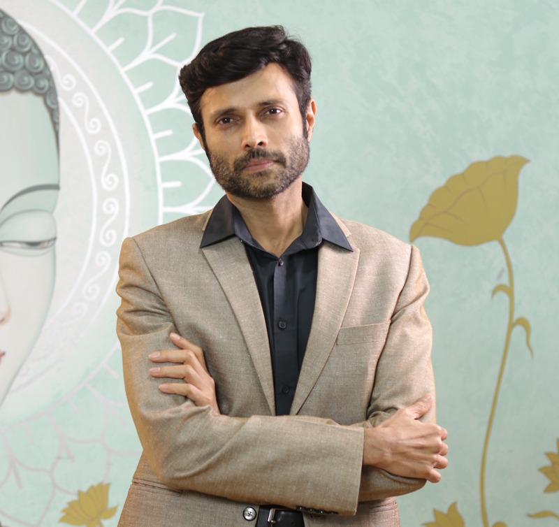 A man wearing glasses and a black shirt.