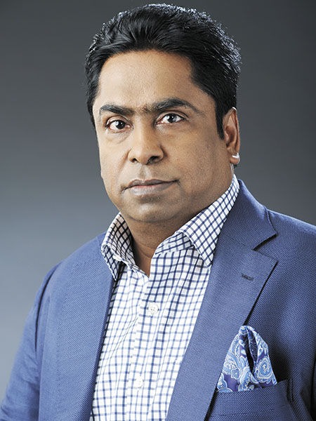 A woman in a strapless dress posing for a picture.