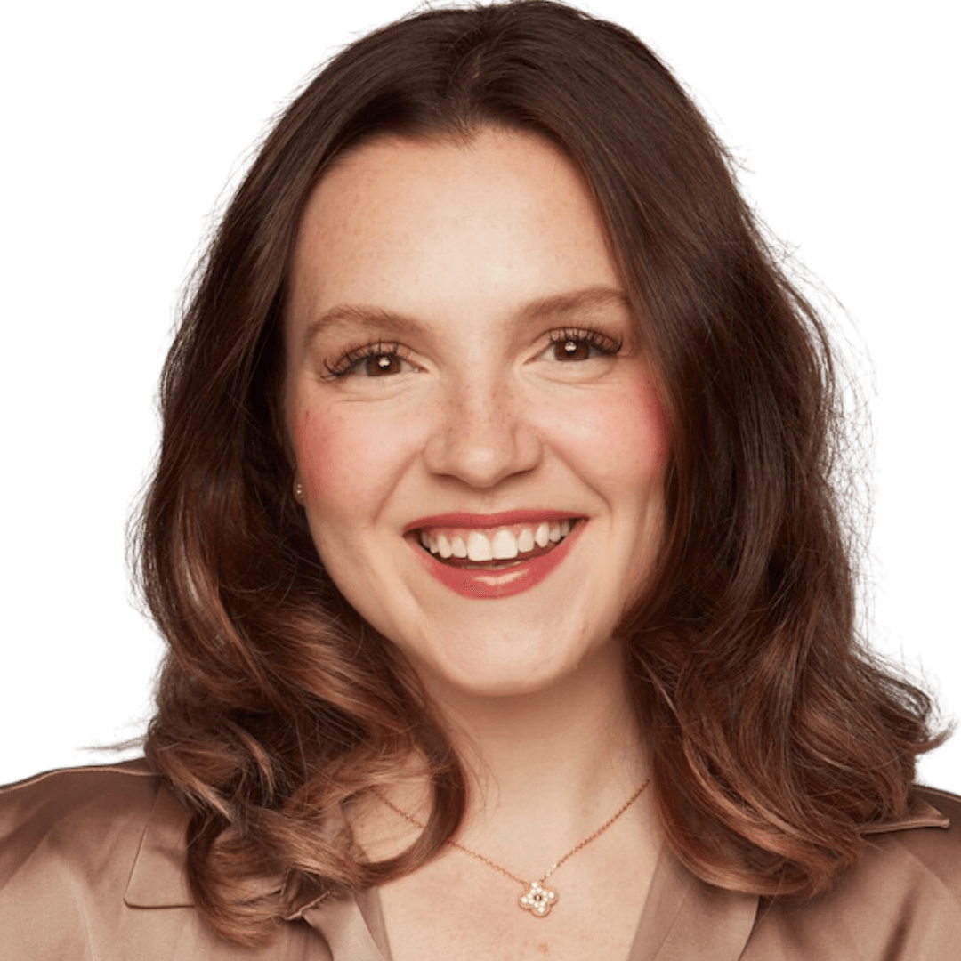 A woman with long brown hair smiling at the camera.