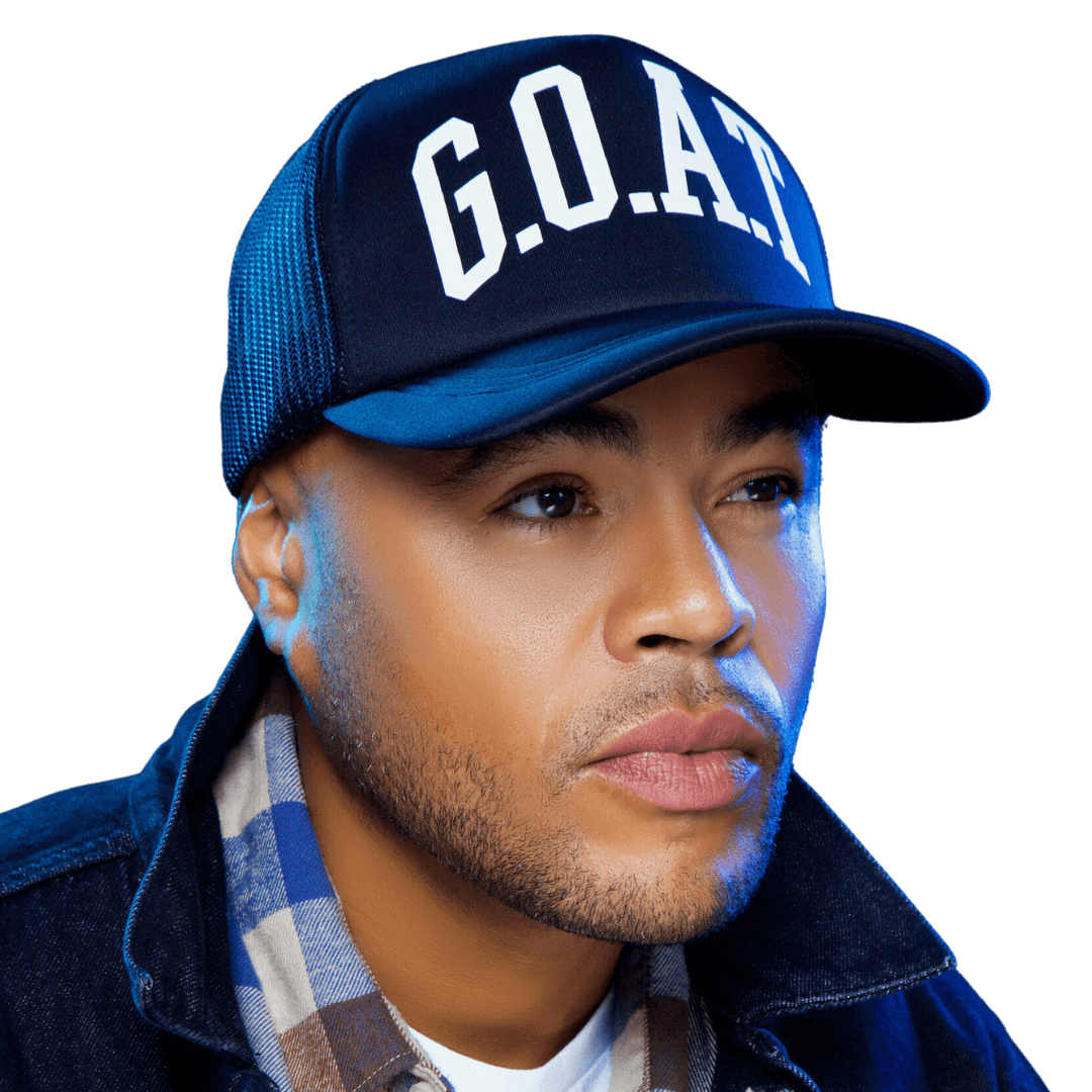 A man wearing a hat with the word goal on it.